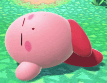 a pink cartoon character with a red hat is laying on a green carpet