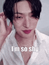 a close up of a man wearing headphones and a white shirt with the words `` i 'm so shy ''