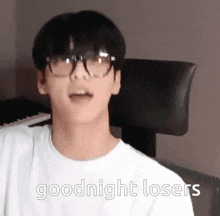 a young man wearing glasses and a white shirt says goodnight losers .