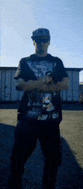 a man with his arms crossed wears a shirt that says ' dirty ' on it