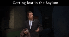 a man in a suit is standing in a dark room with the words " getting lost in the asylum " on the bottom