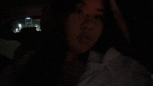 a woman is sitting in the back seat of a car