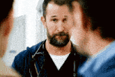 a man with a beard and stethoscope around his neck