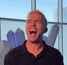 a man in a black shirt with his mouth wide open