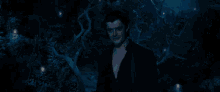 a woman with horns is sitting in the dark