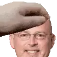 a man wearing glasses and a hat is being slapped on the head by a hand .