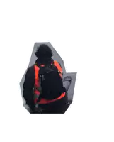 a man wearing an orange vest and a black backpack is walking