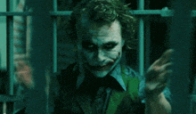 a close up of a man with a joker face paint on