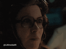 a close up of a woman 's face with glasses and the hashtag lialmeida05