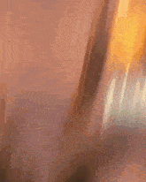 a blurry picture of a person holding a sword in their hand .