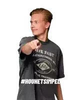 a young man wearing a t-shirt that says live fast achieve everything