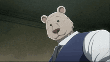 a white teddy bear in a suit and tie looks at the camera