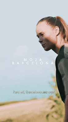 a woman is running in a field with the words " para mi barcelona era aqui " written on the bottom
