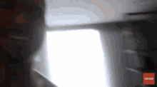 a blurred image of a person with a subscribe button on the bottom right