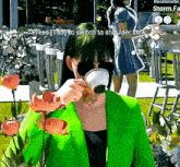 a woman in a green jacket drinking from a cup with the words press tab to switch to shoulder view above her