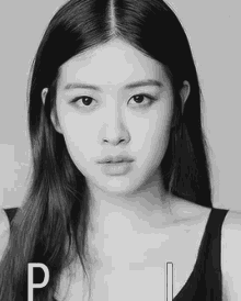 a black and white photo of a young woman with long hair .