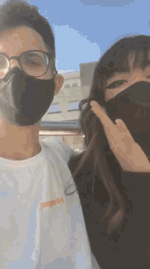 a man and a woman wearing face masks