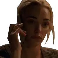 a woman is talking on a cell phone with a serious look on her face