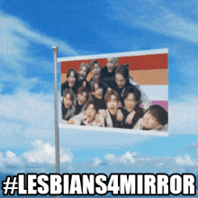 a flag with a picture of a group of people and the words lesbians4 mirror
