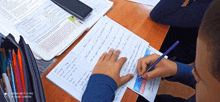 a redmi note 8 pro is being used to take a picture of a child writing