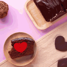 a slice of chocolate cake with a red heart in it