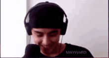 a man wearing headphones with the name mayward on the bottom right