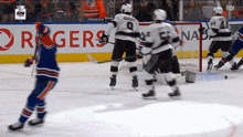 a hockey game is being played in front of a banner for rogers
