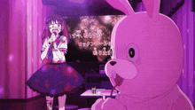 a girl singing into a microphone next to a stuffed bunny