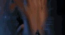 a woman is dancing in a dark room in front of a mirror in a dark room .