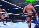a man in a wrestling ring has austin theory on the back of his shorts