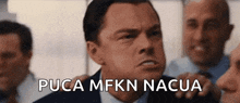 a man in a suit and tie says pucca mfkn nacua in front of other men