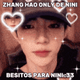 a man wearing a hat has hearts around his face and says zhang hao only de nini besitos para nini 33