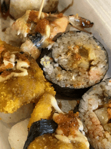 a close up of a tray of food including sushi