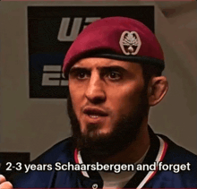 a man with a beard wearing a burgundy beret says 2-3 years schaarsbergen and forget
