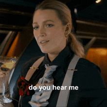 a woman with a martini in her hand is asking do you hear me