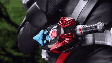 a close up of a person 's belt with a red and black object on it