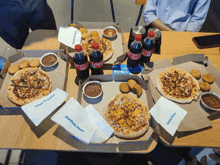 several domino 's pizza boxes on a table