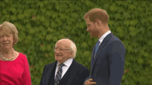 a group of people are standing next to each other and talking