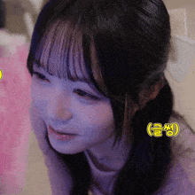 a close up of a girl 's face with a foreign language sticker