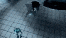 a person is standing on a tiled floor in the dark .