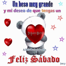 a teddy bear holding a red heart with the words un beso muy grande y mi deseo de que tengas un