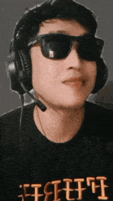 a man wearing headphones and sunglasses is wearing a black shirt that says fft