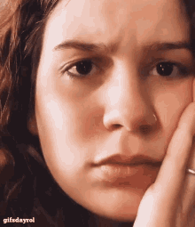 a close up of a woman 's face with a gifsdayrol watermark