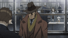 a man in a hat and coat stands in front of a glass wall