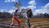 a woman in red pants is fighting a man in a video game