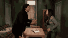 a priest and a woman are having an argument in a room