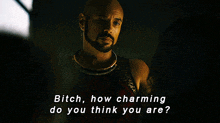 a man with a beard says " bitch how charming do you think you are " in a dark room