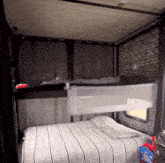 a bed with a striped blanket and a laundry detergent bottle