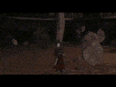 a woman is looking up at something in a dark cave .