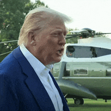donald trump is standing in front of a helicopter